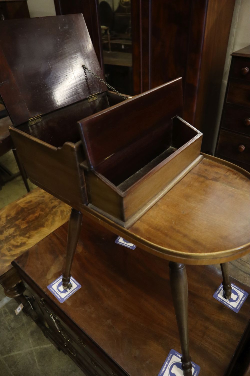 A Victorian mahogany sewing table on slender splayed baluster legs with brass caps and castors, width 54cm depth 33cm height 70cm